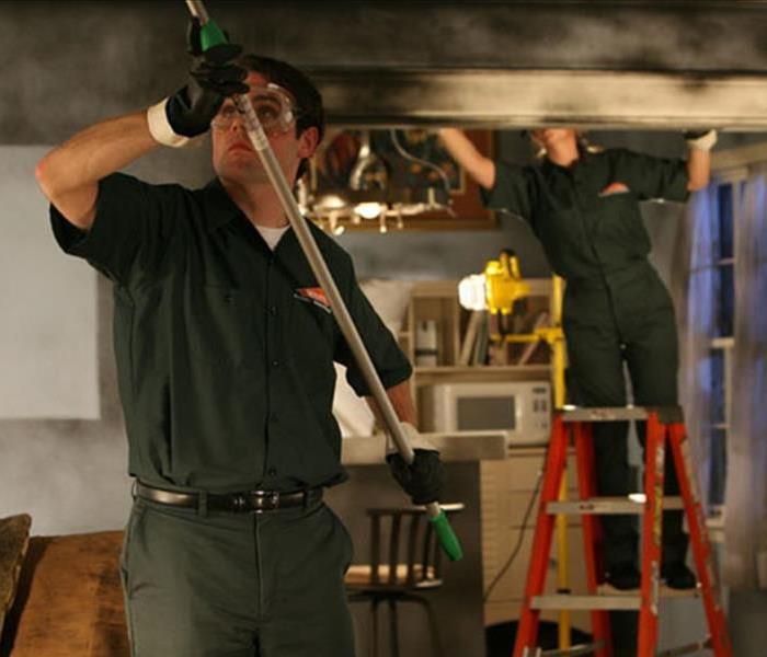 SERVPRO team members cleaning soot damages
