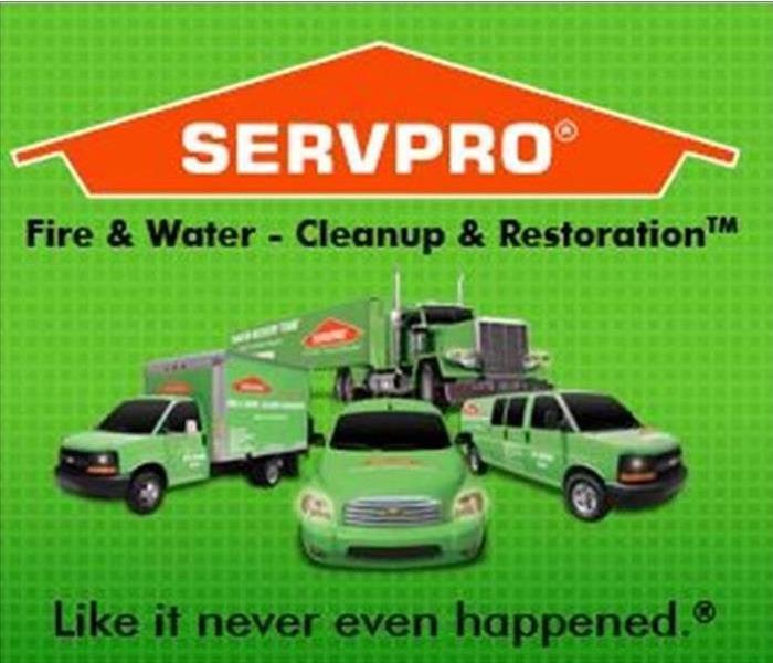 Green SERVPRO trucks and orange logo