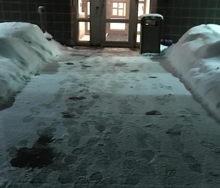 Snowy commercial walkway that has been shoveled