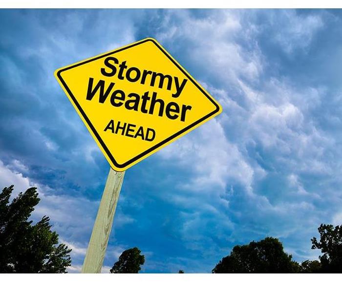 yellow street sign saying stormy weather ahead
